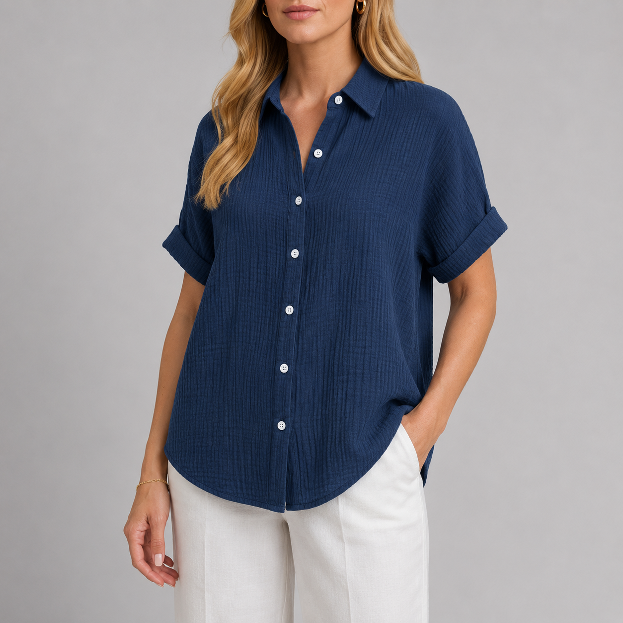 Textured button-up shirt with collared neckline, rolled short sleeves, and relaxed oversized fit