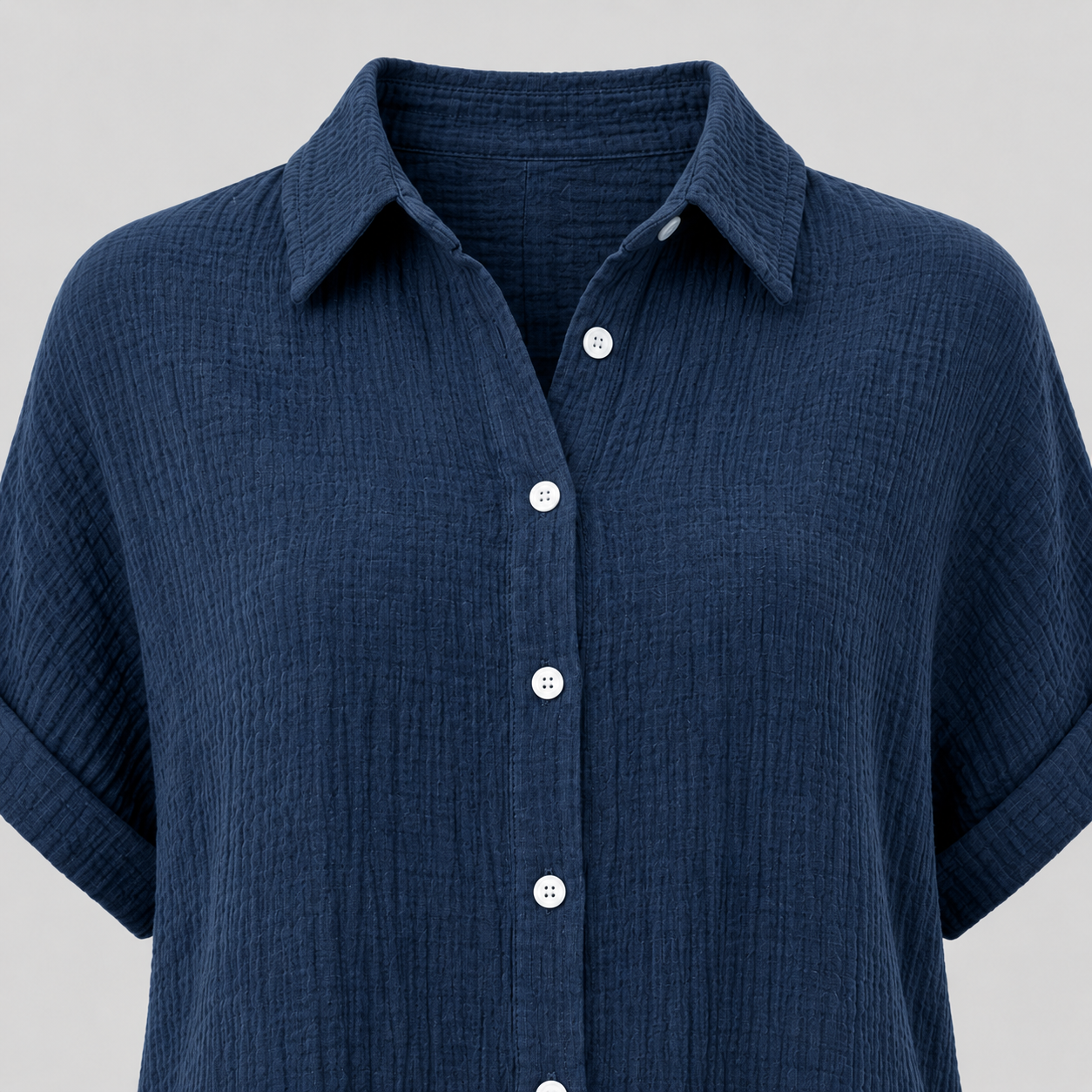 Textured button-up shirt with collared neckline, rolled short sleeves, and relaxed oversized fit