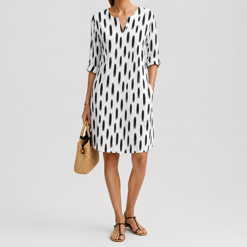 White dress with black abstract print and rolled sleeves