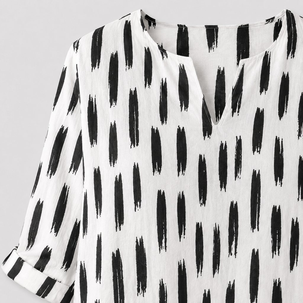 White dress with black abstract print and rolled sleeves