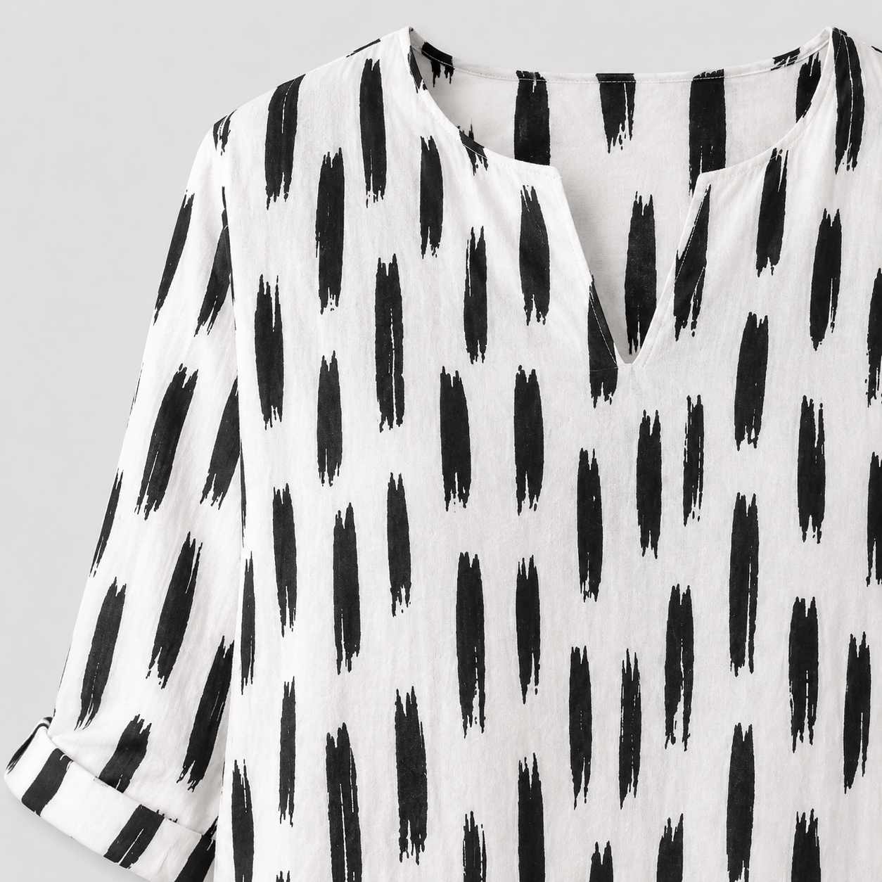 White dress with black abstract print and rolled sleeves