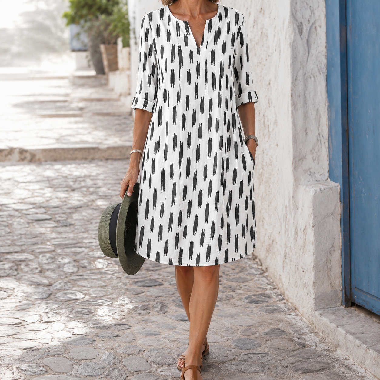 White dress with black abstract print and rolled sleeves