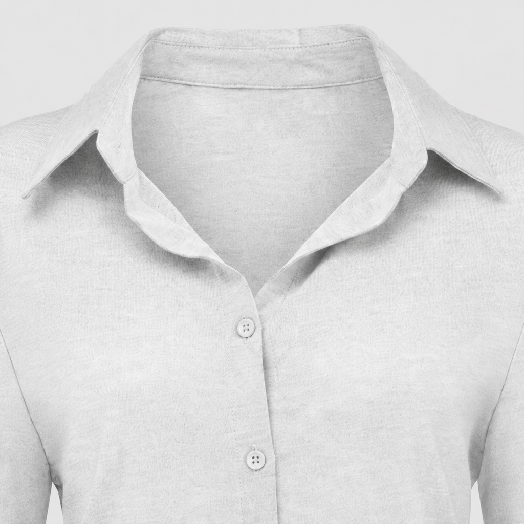 Long sleeve button-up shirt with collared neckline, tailored fit, and curved hem