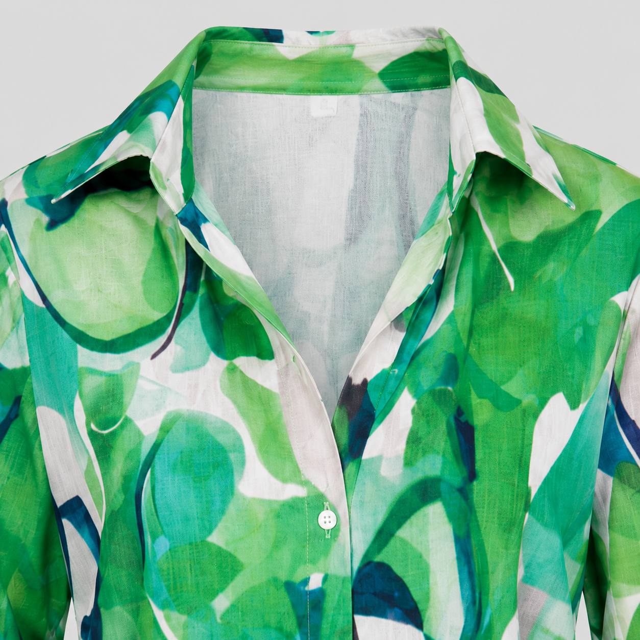 Abstract print blouse with split V-neck, button-front detail, and long sleeves in a relaxed silhouette