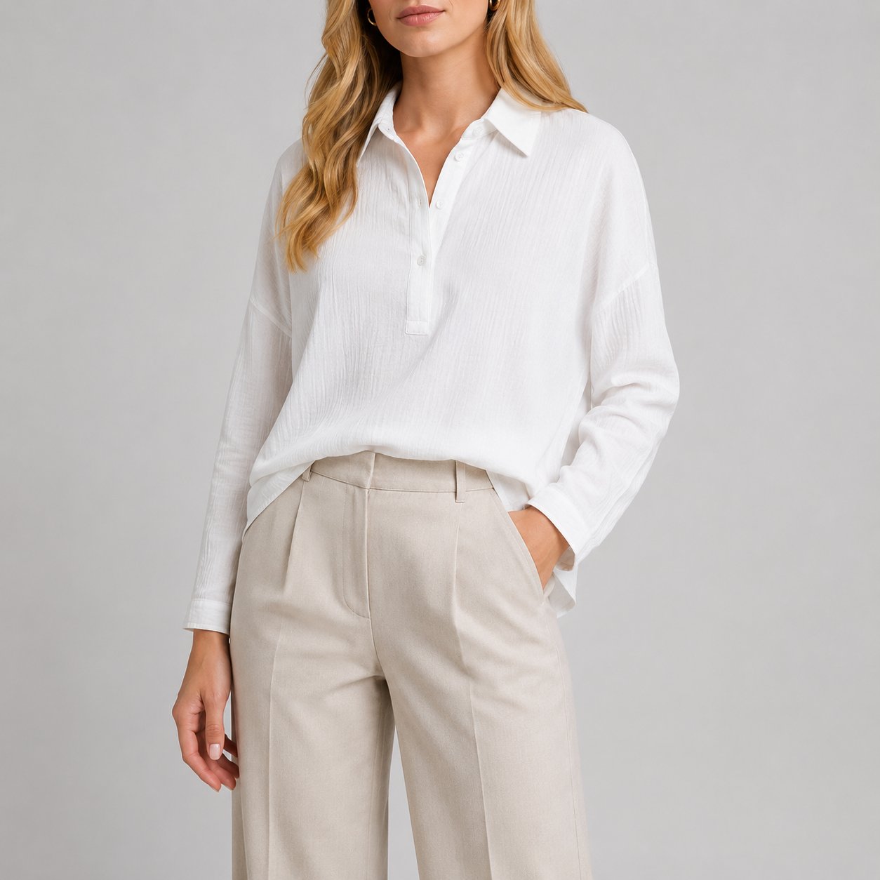 Long sleeve oversized polo shirt with pointed collar, partial button placket, and relaxed silhouette