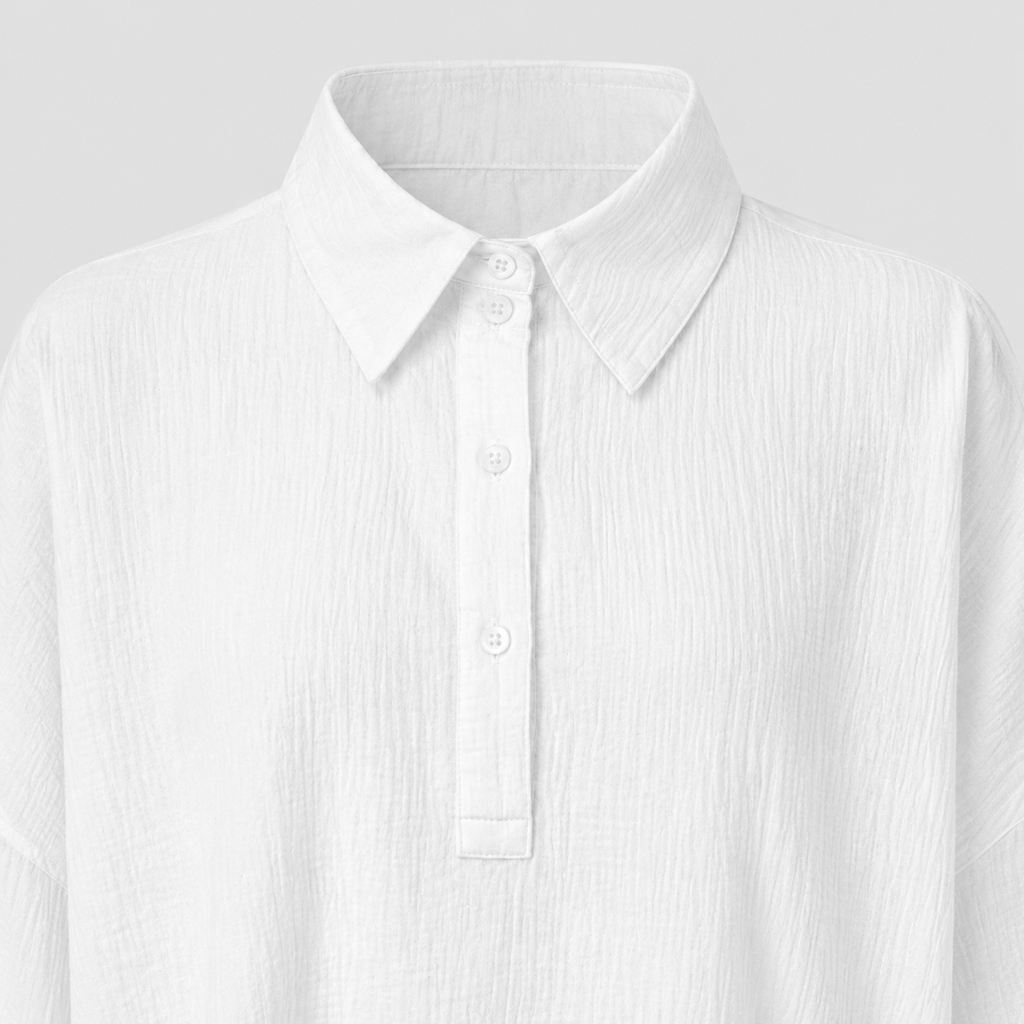 Long sleeve oversized polo shirt with pointed collar, partial button placket, and relaxed silhouette