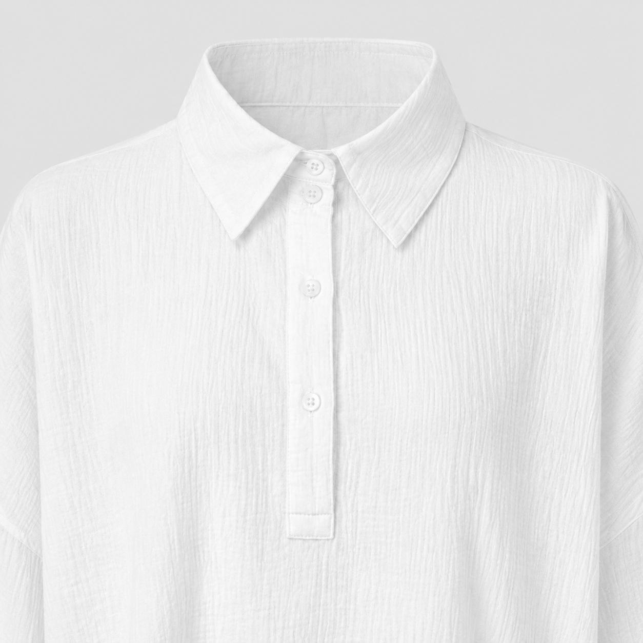 Long sleeve oversized polo shirt with pointed collar, partial button placket, and relaxed silhouette